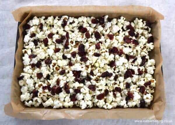 How to make Cranberry and White Chocolate Popcorn - Easy treat recipe that is perfect for a festive family movie night - Eats Amazing UK