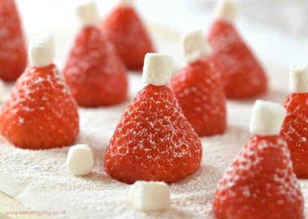 Easy Christmas Party Food Idea - these simple strawberry Santa hats are perfect for snacks or a North Pole Breakfast - Eats Amazing