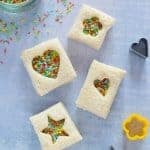 Cute mini fairy bread sandwiches made with homemade rainbow coconut sprinkles - perfect for lunch boxes and kids party food