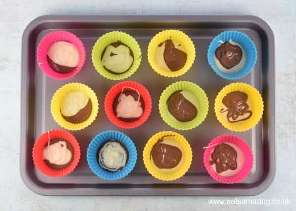 Easy Easter Giant Chocolate Buttons Recipe - Step 1 spoon melted cocolate into cupcake cases