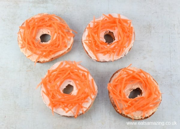How to make healthy Easter nest bagels - step 4 arrange the carrot strips on top of each bagel to form nests