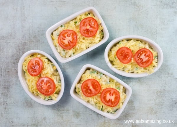 Individual macaroni cheese portions topped with sliced tomato - easy recipe from Eats Amazing UK