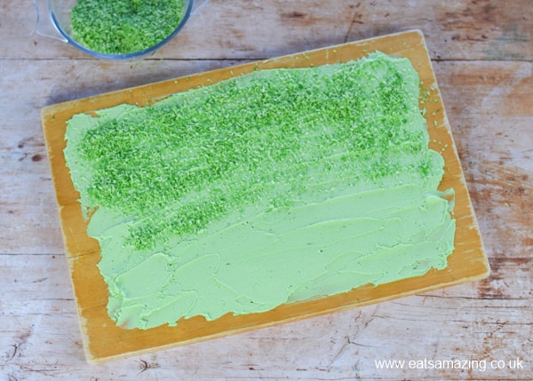 Birthday cake idea for kids - fun snake cake recipe - step 6 cover cake board in icing and coconut grass