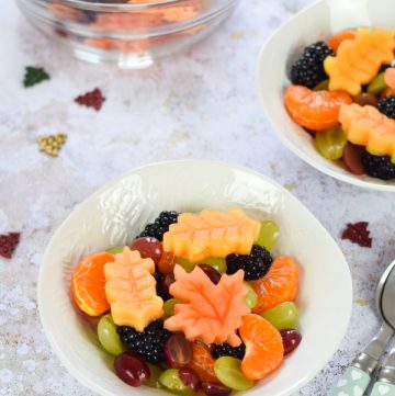 Pretty autumn fruit salad with edible autumn leaves - healthy fun food for kids