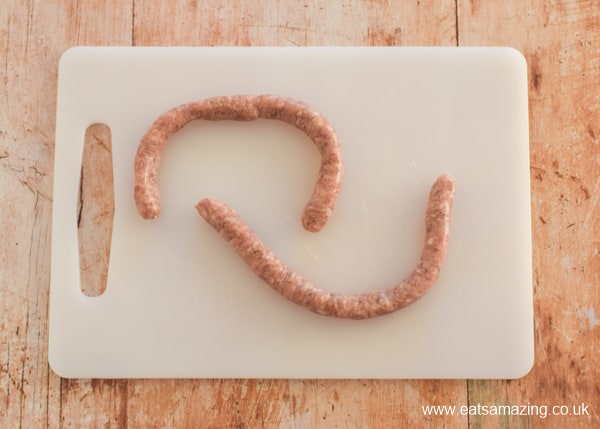 Cumberland sausage swirls on a stick - fun fireworks recipe - Step 2 unwind sausages and squash the filling to make each pair into one long sausage