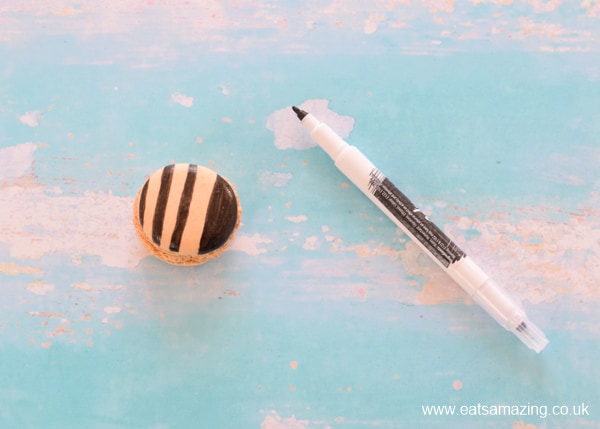 How to make cute bee macarons - step 1 draw on stripes with edible pen