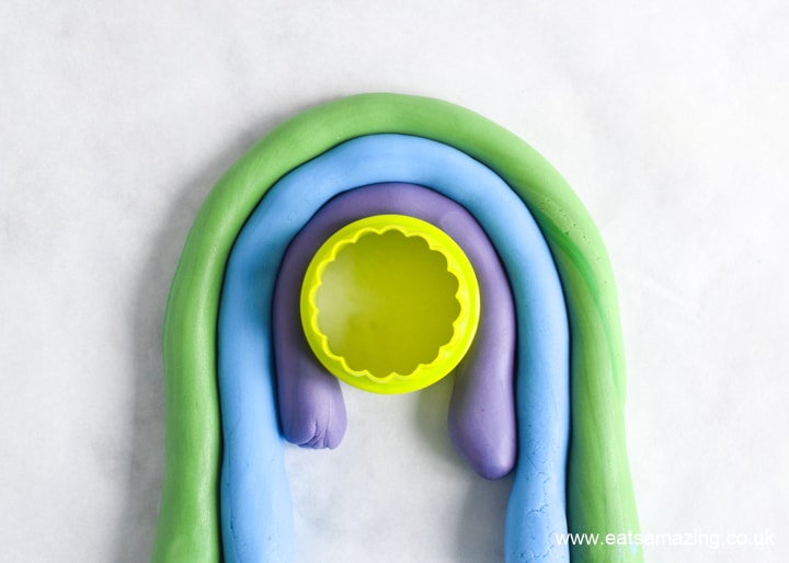 How to make a fondant rainbow cake decoration - step 3 continue with the rest of the colours to make a rainbow