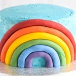 How to make a fondant rainbow cake decoration - step 8 repeat until complete rainbow is on the cake