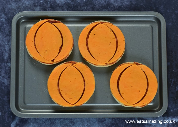 How to make Halloween Pumpkin Pizzas - step 4 place cheese on each pizza