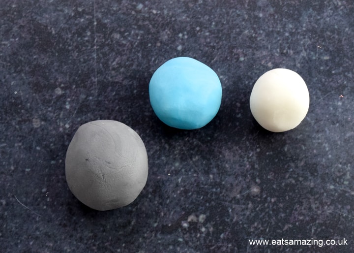 How to make an easy Among Us Crewmate Cake - step 7 colour balls of fondant icing to pale grey blue and white