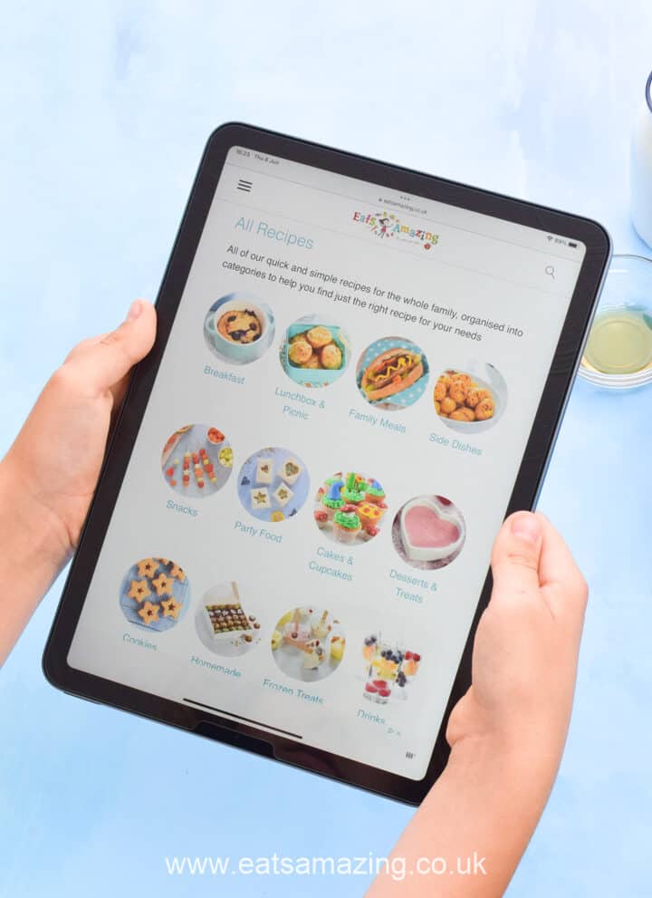 iPad Air held in the hands of a child, displaying Eats Amazing website recipe categories